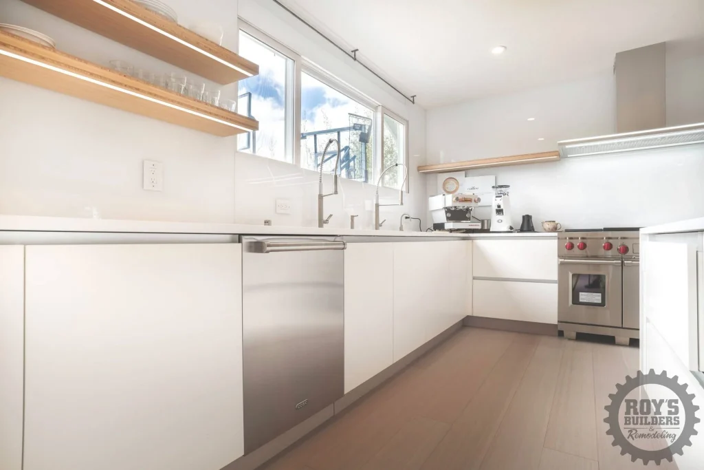 Minimalist White Kitchen With Wood Accents- Roy's Builders and Remodeling
