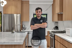 Man smiling in a Modern kitchen with wood cabinets in Bayport, San Carlos, CA