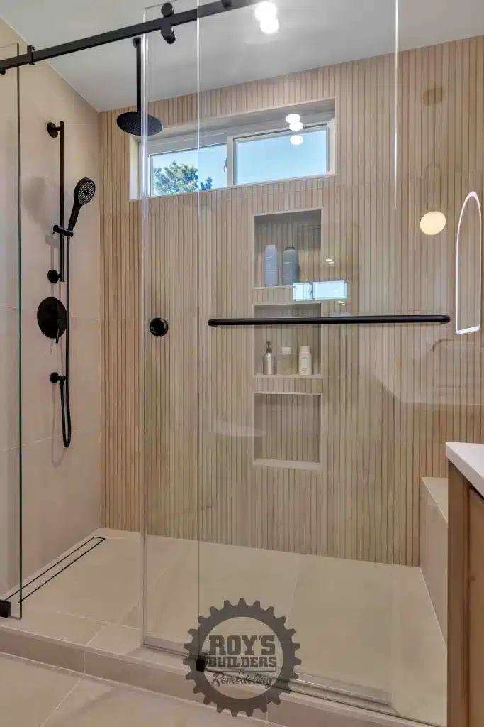 Glass shower with wood-look tile and niche