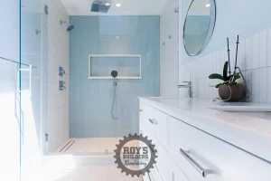 Walk-in shower with pale blue tile and a white double vanity in a remodeled Palo Alto bathroom