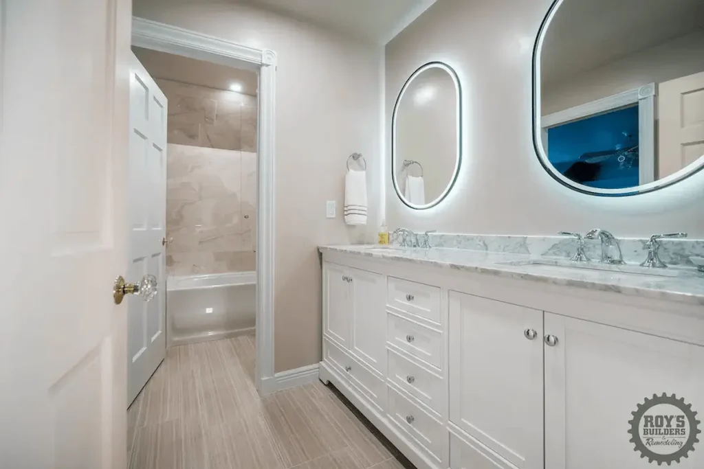 Vanity with backlit oval mirrors and marble top