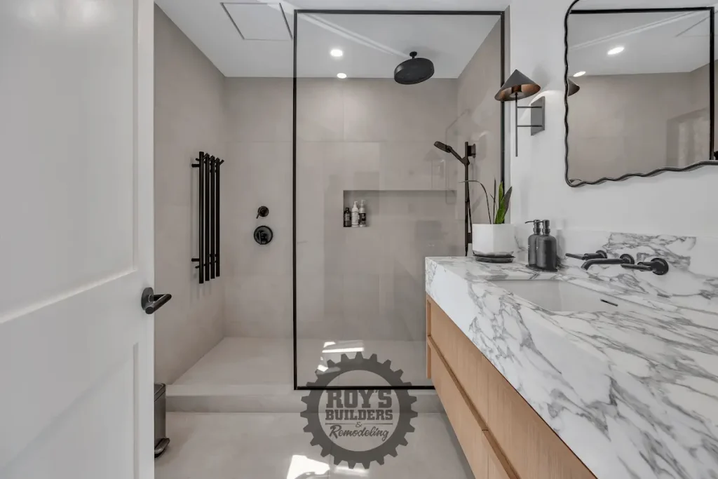 Marble vanity beside tiled walk-in shower