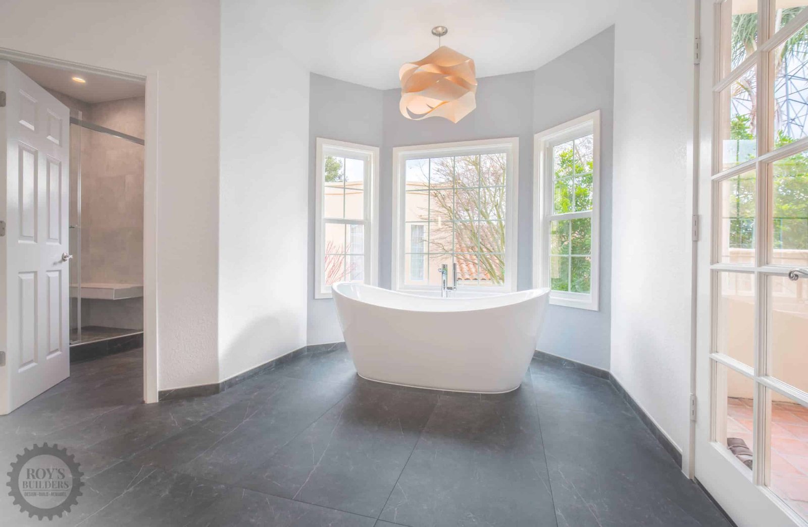 Freestanding bathtub near large window
