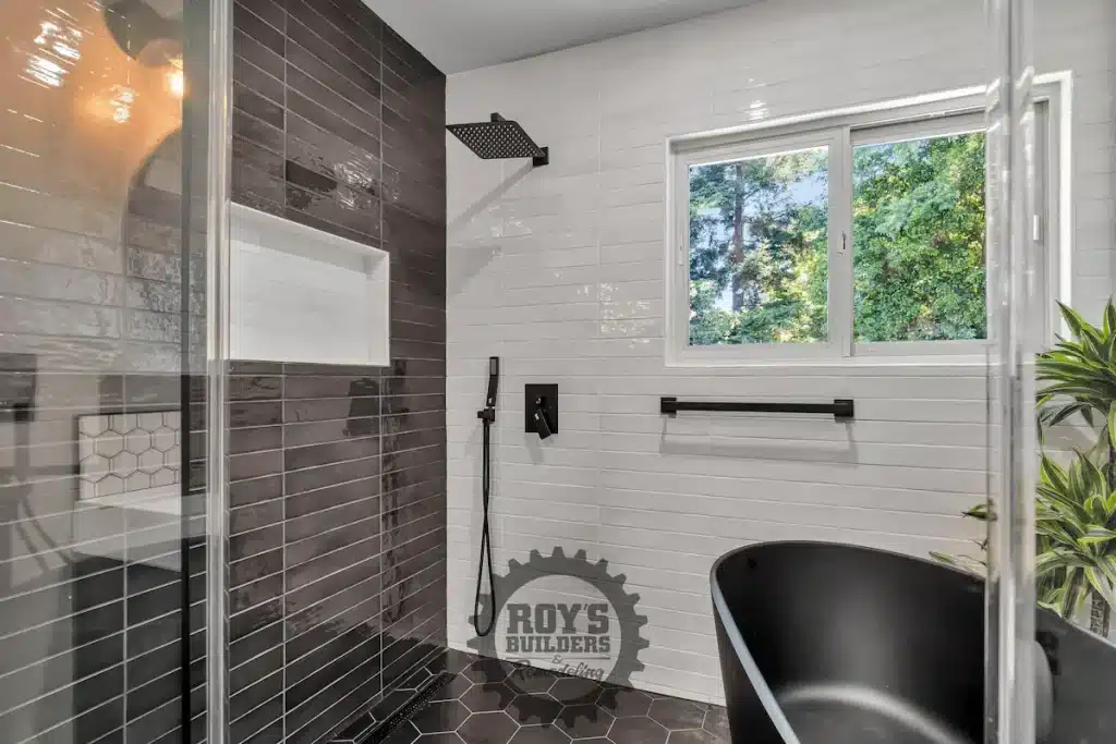 Bathroom featuring tub and large window