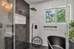 Bathroom featuring tub and large window