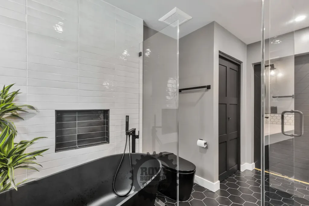 Black freestanding tub beside tiled shower