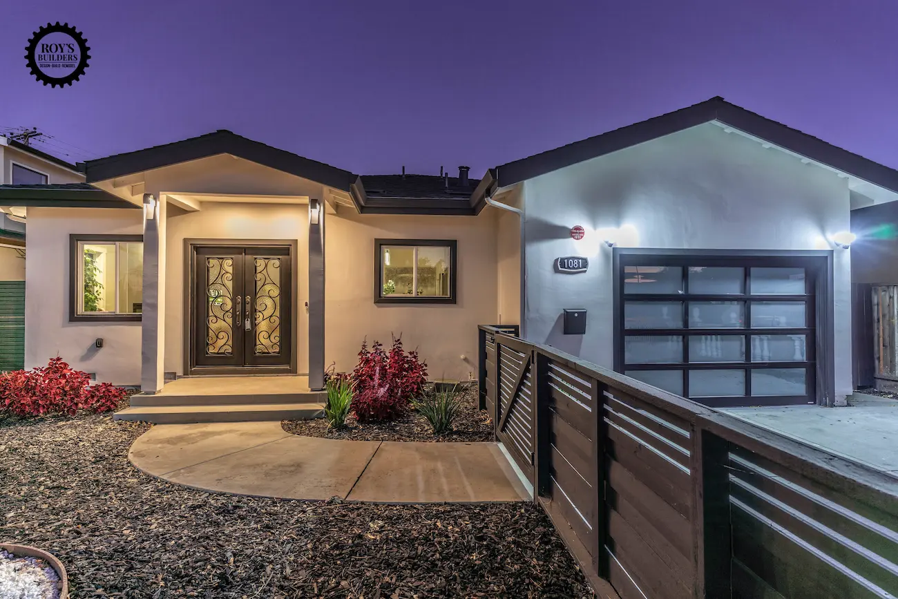 a modern single-story residential home with a garage featuring a frosted glass sectional door and a dark-framed double entry door