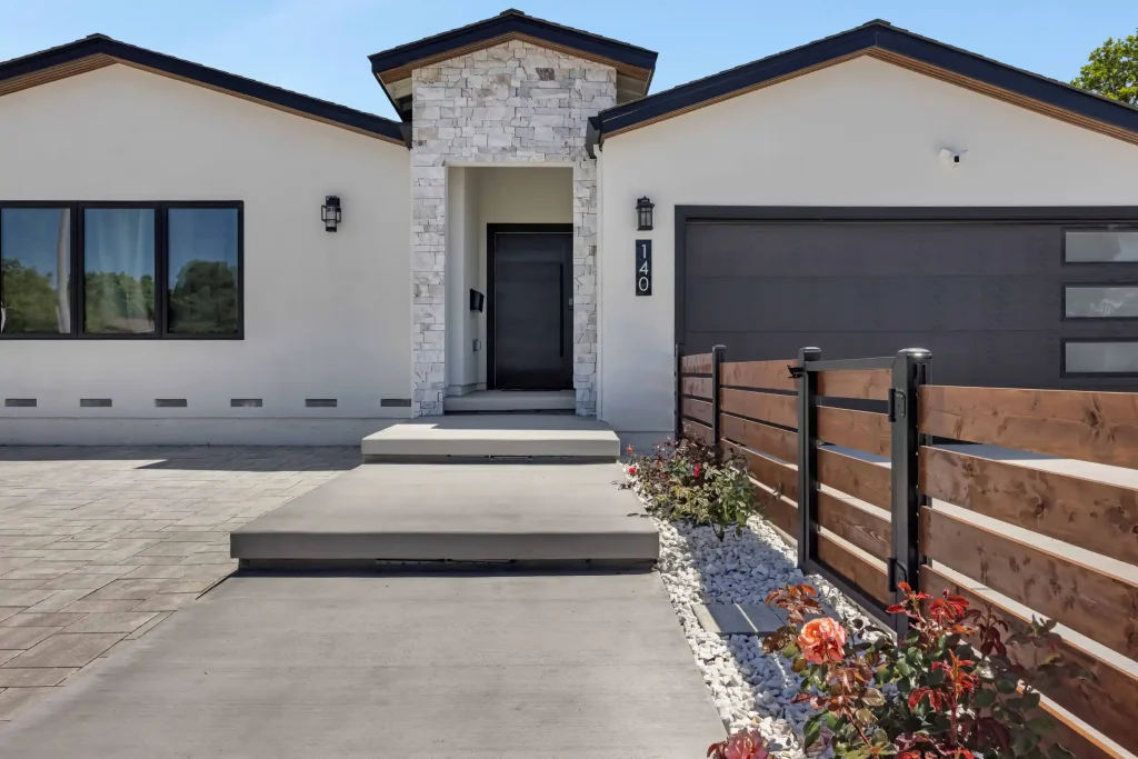 Front elevation view of a contemporary house with an entry gate.