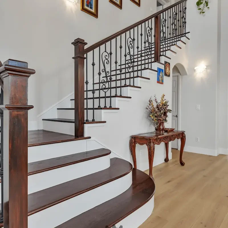 Modern staircase with wooden steps and black railing