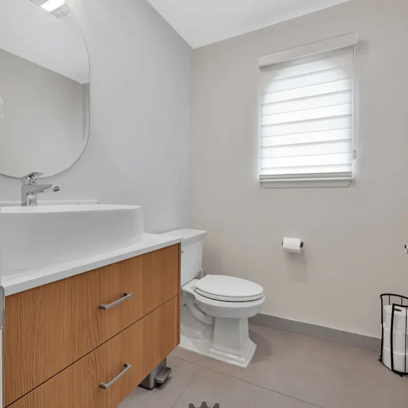 Clean bathroom with toilet and sink area