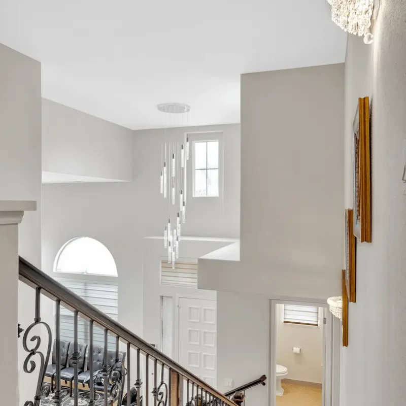 View of the staircase with white walls and railings
