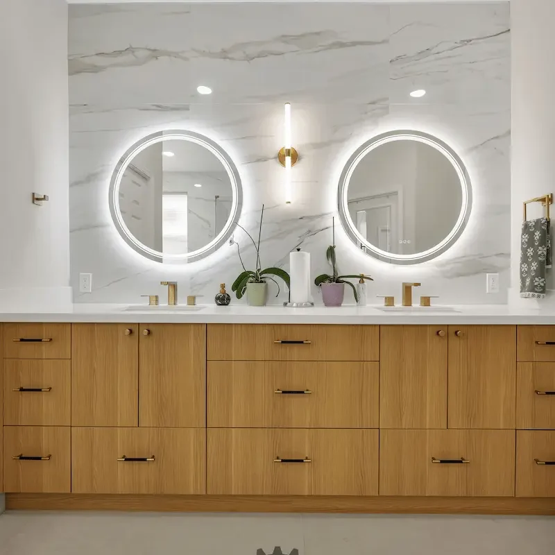 Bright bathroom with dual circular backlit mirrors