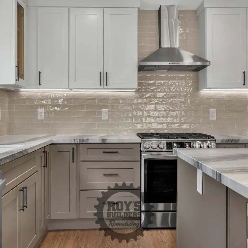 Bright kitchen setup featuring a stainless steel under-mount sink and tile backsplash.