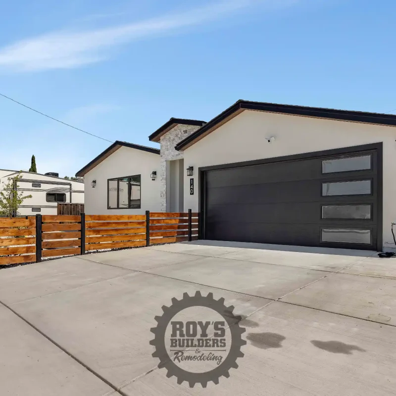 Smooth concrete driveway leading to a modern two-car garage.