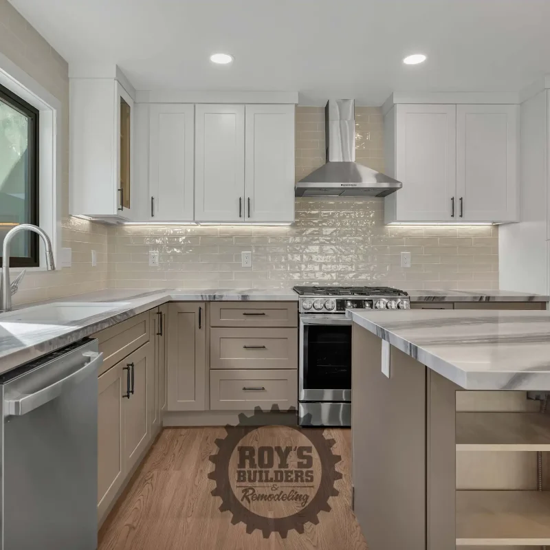 Contemporary L-shaped kitchen layout with white shaker cabinets and a stainless steel range.