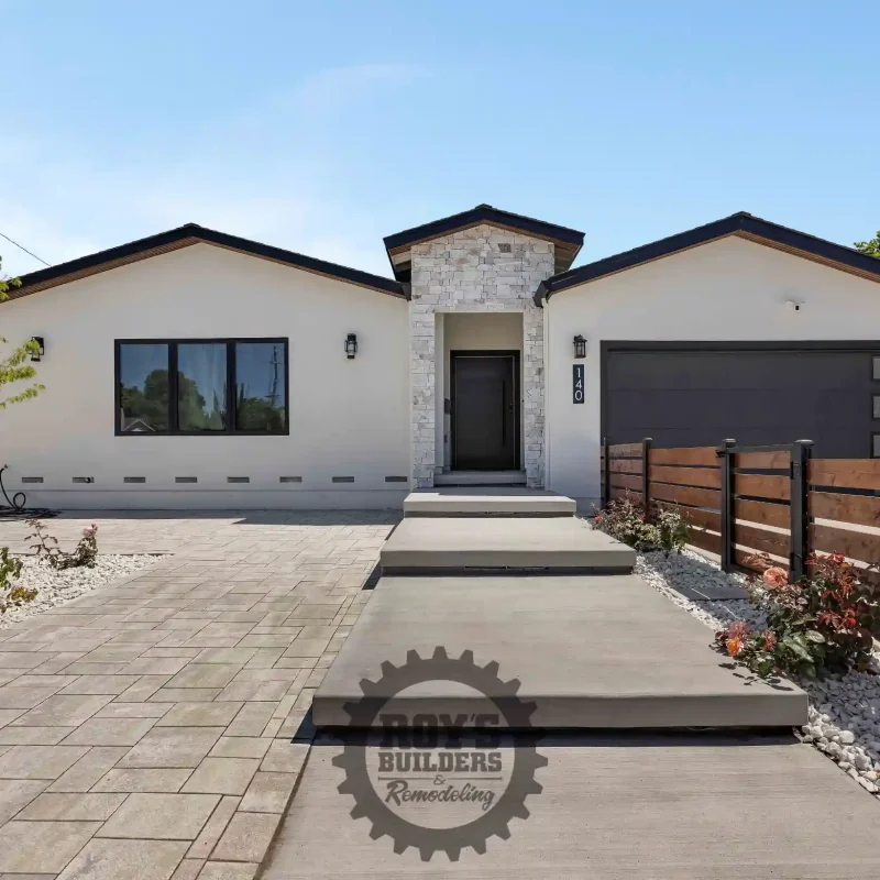 Entryway path leading to the front door of a modern stucco house.
