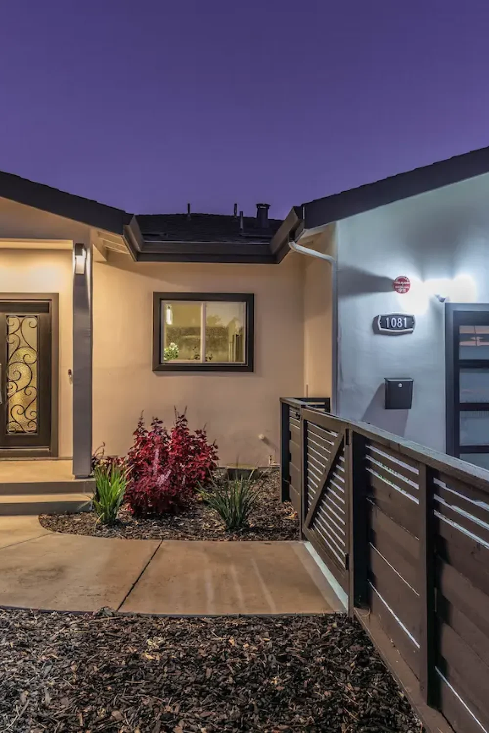 a modern single-story residential home with a garage featuring a frosted glass sectional door and a dark-framed double entry door
