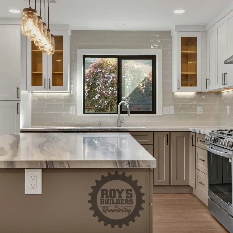 Close-up of a kitchen countertop with a gas stove and tile backsplash.