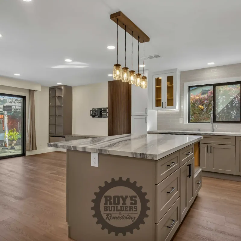 Kitchen island view overlooking the living space and outdoor windows.