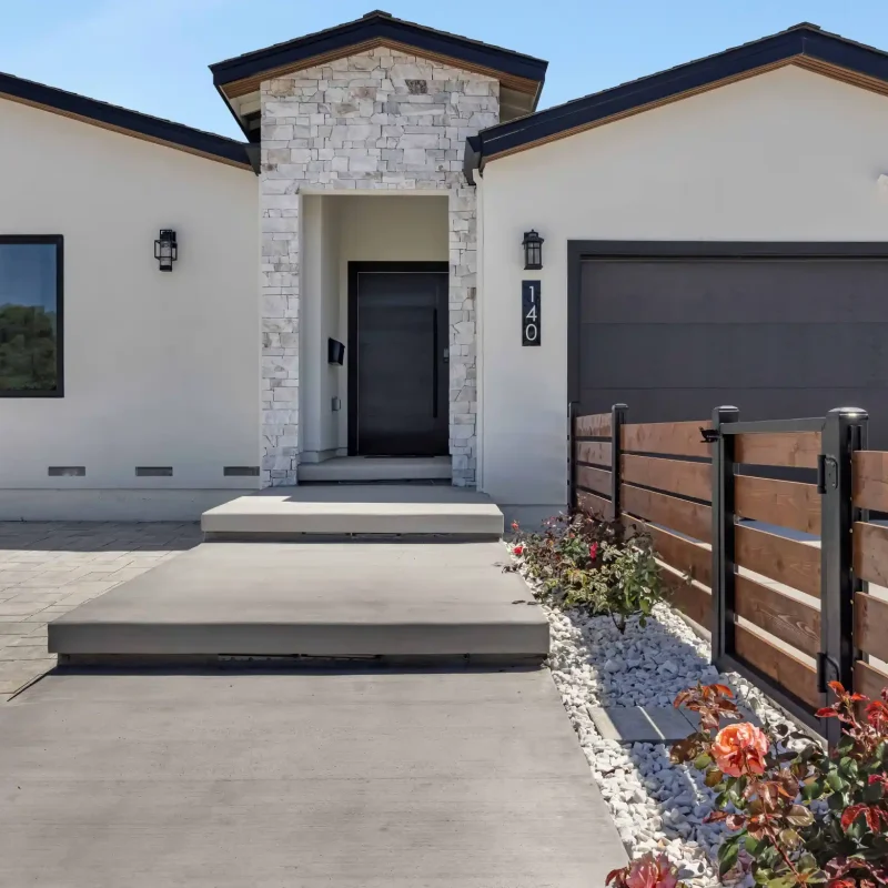 Front elevation view of a contemporary house with an entry gate.