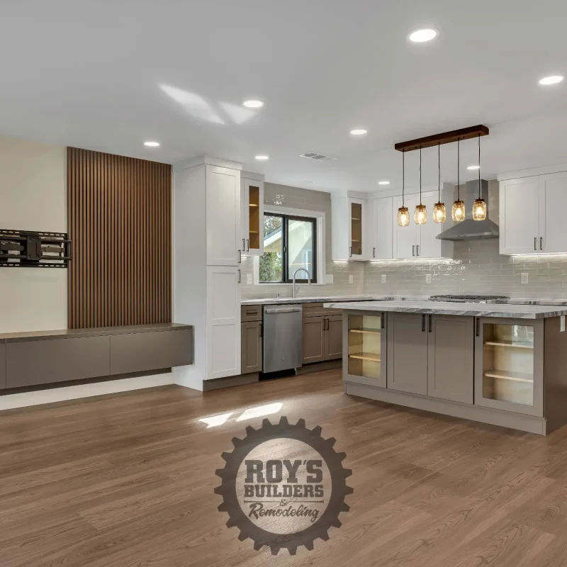 Sleek modern kitchen featuring white upper cabinets and light wood lower cabinets.