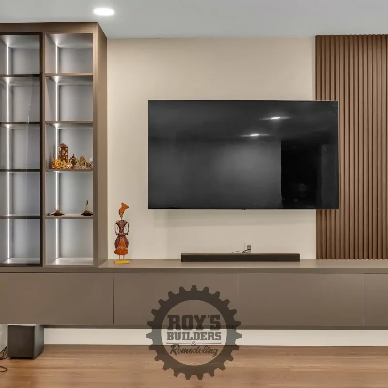 Contemporary living area with a wall-mounted TV and light wood accent panels.