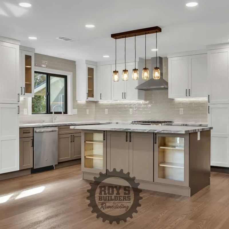 Bright open-concept kitchen with white cabinets and a center island.