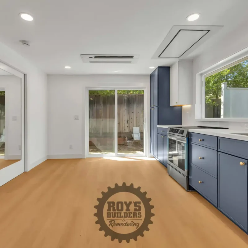 Open living area showing the connection between the kitchen and a sliding patio door.