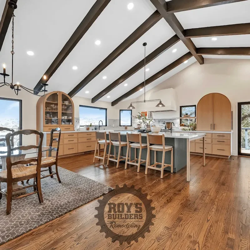 Spacious kitchen with light wood tones and appliances.