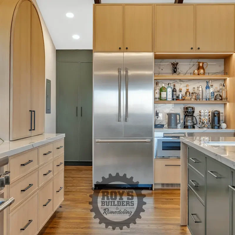Spacious kitchen with large island and chairs.