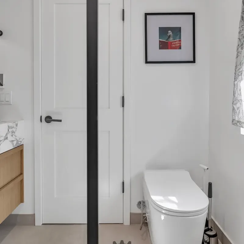 White bathroom with a shower and clean design.