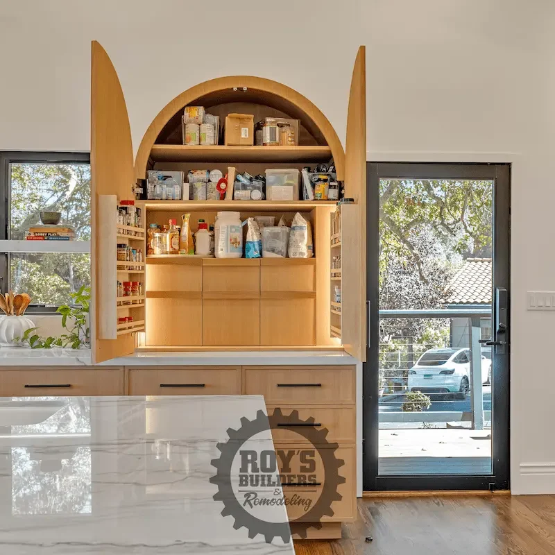 Shelf unit with wooden arch and books.