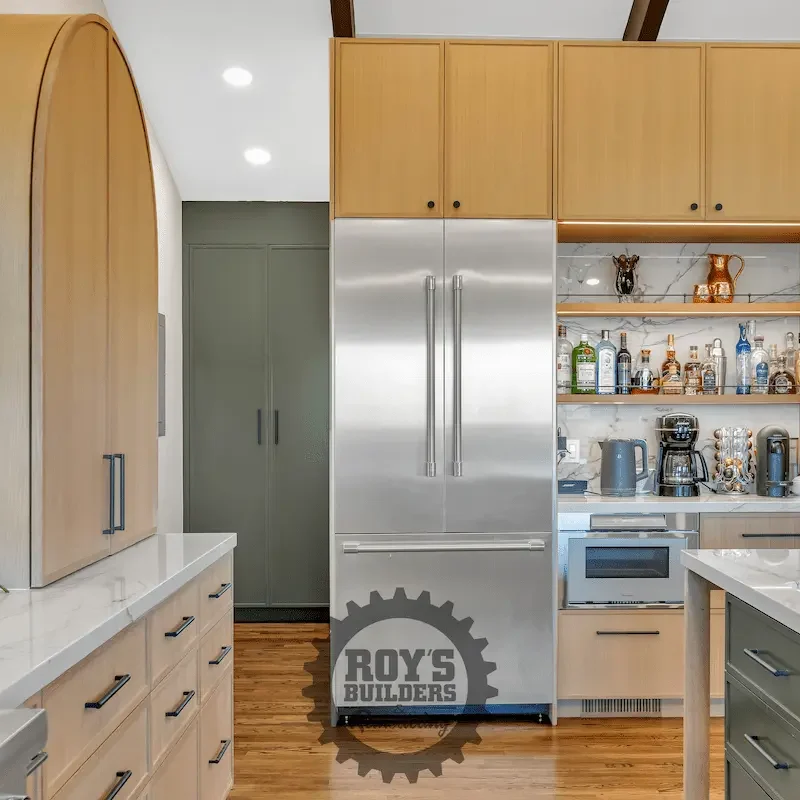 Kitchen with stainless steel fridge and cabinets.