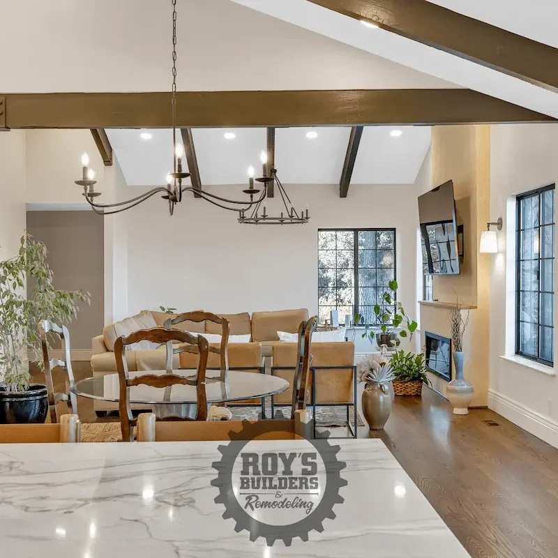 Open dining area with a wooden table and windows.