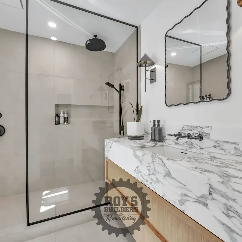 Bathroom shower with glass walls and fixtures.