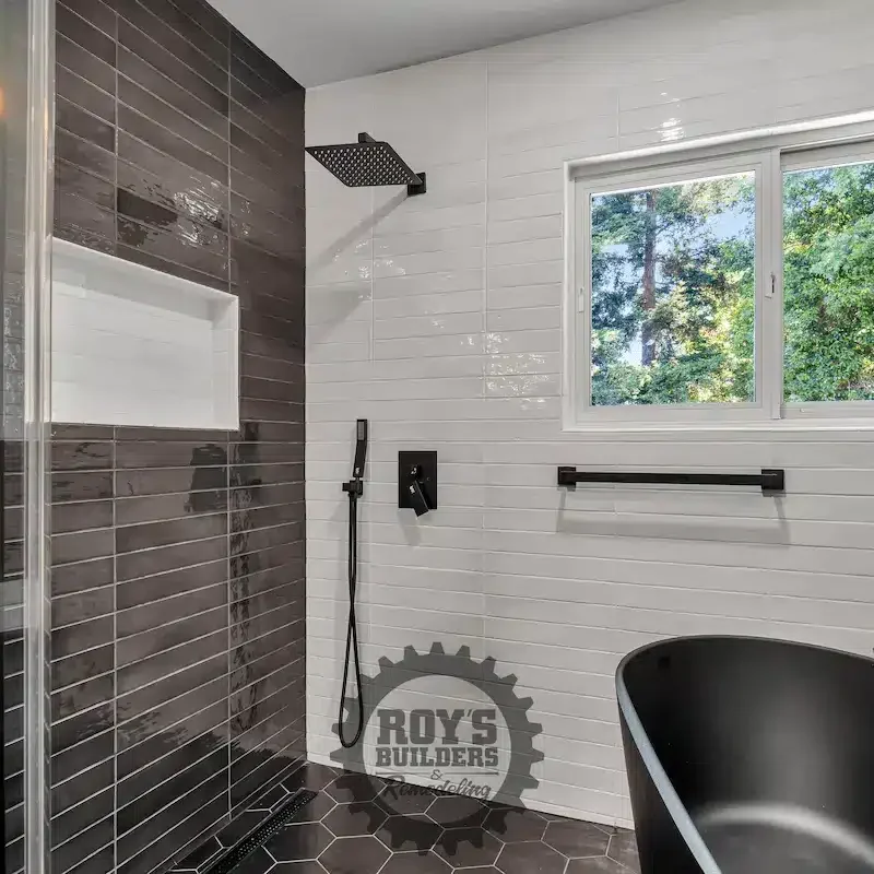 Bathroom featuring tub and large window