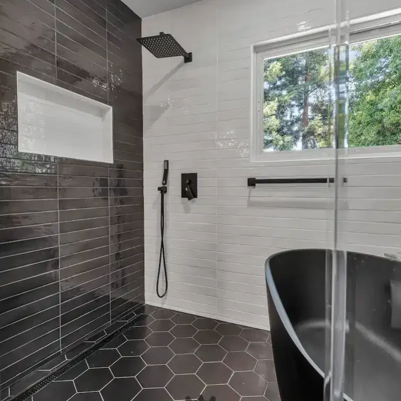Black tile shower with glass divider