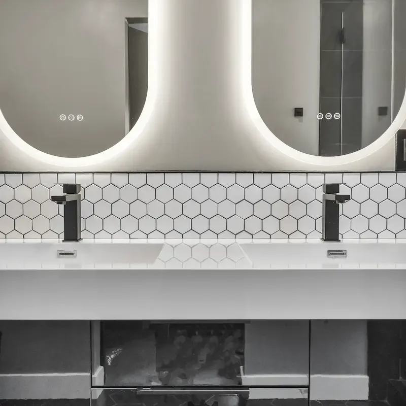 Modern vanity with twin mirrors and backsplash
