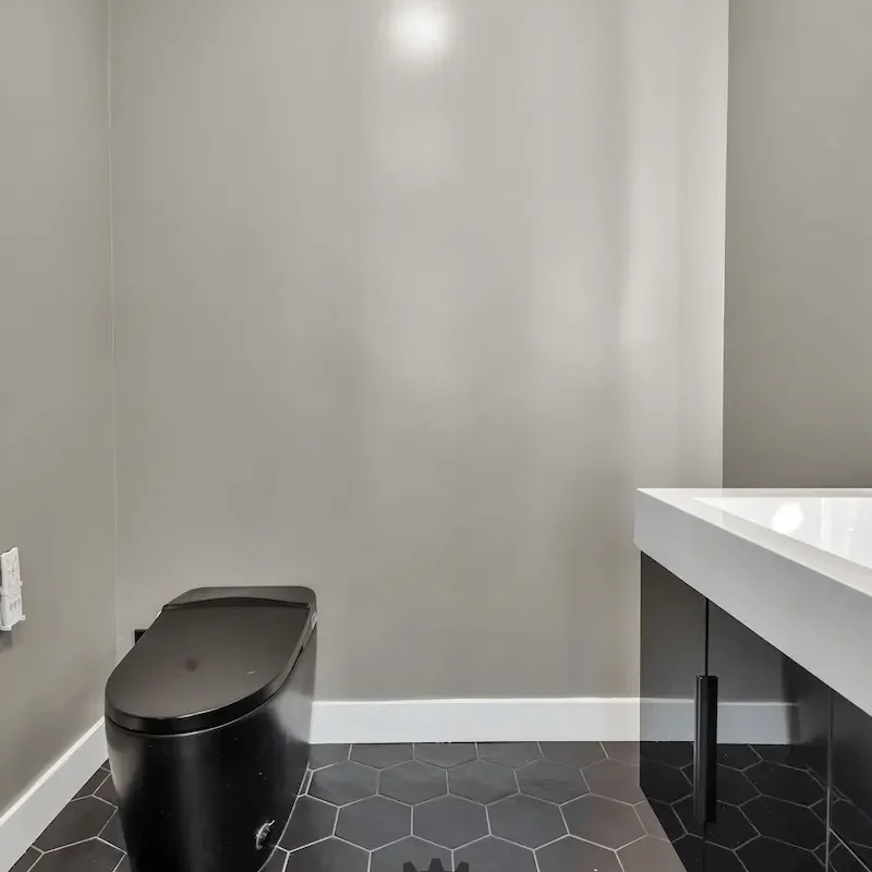 Minimalist bathroom wall with dark flooring