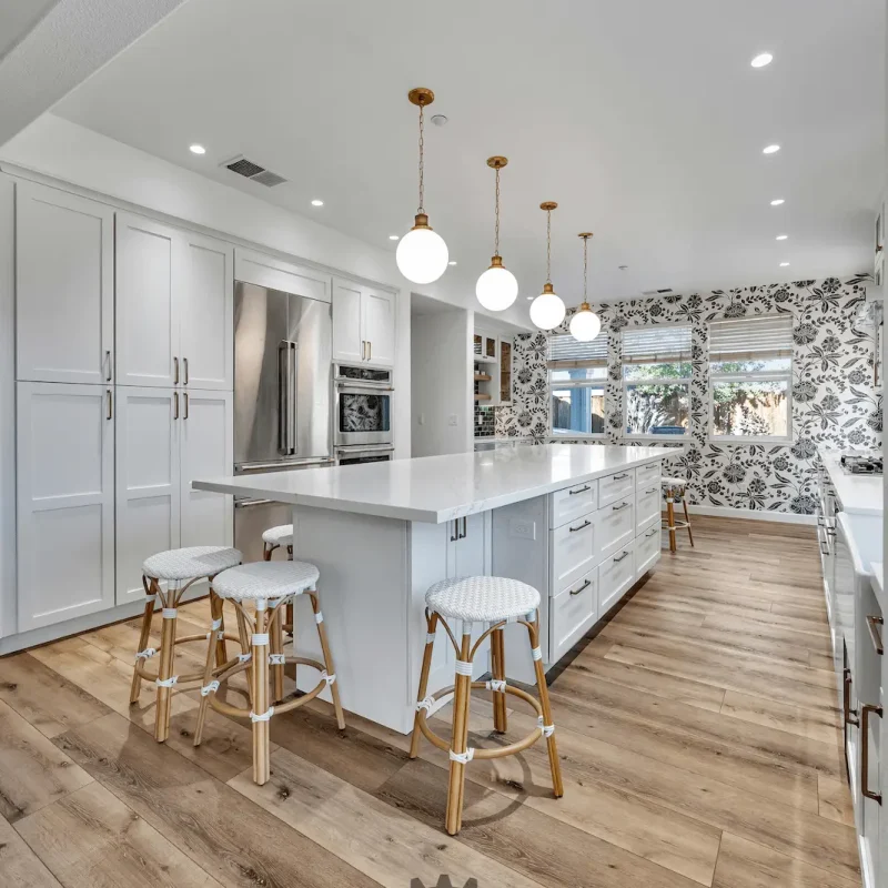 White cabinetry with wood flooring