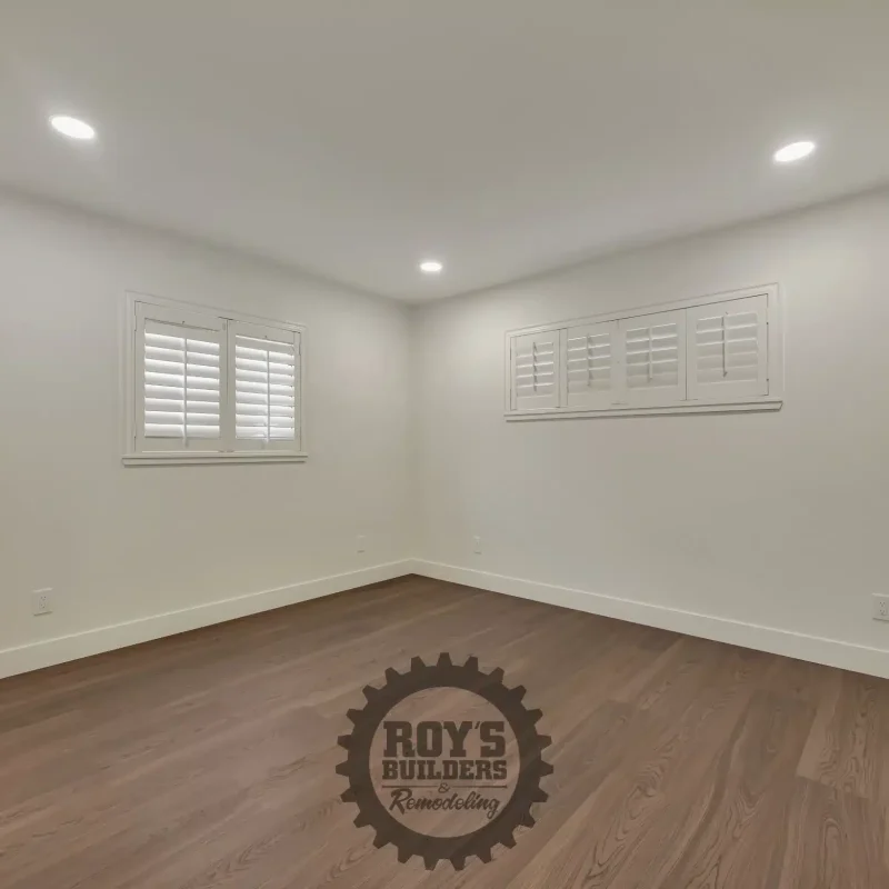 Bright, empty bedroom featuring neutral walls and tile flooring.