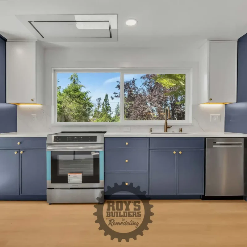 Straight-on view of the kitchen counter with an integrated stainless steel range and range hood.